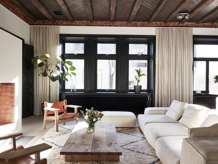 black windows, white sofas and leather chairs