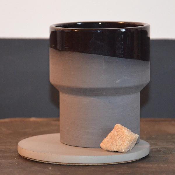 Handmade in Amsterdam, this dark brown-black ceramic cup has an inner transparent gloss glaze. 
