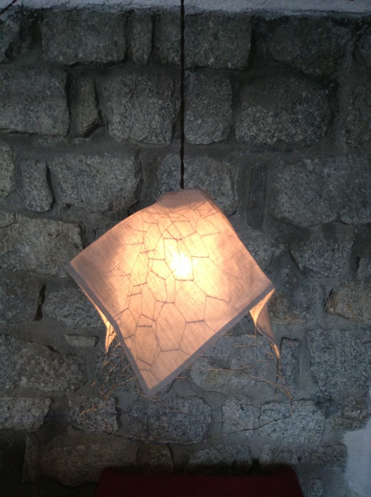 a simple light against a grey brick wall