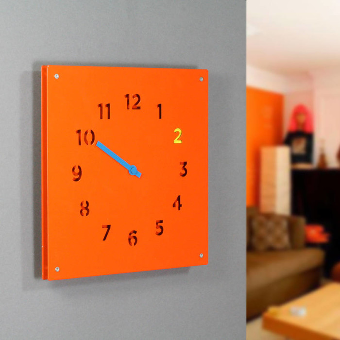 steel wall clock in orange and neon by block design