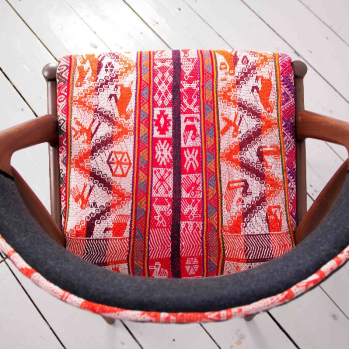 peruvian textiles on a danish chair from a rum fellow