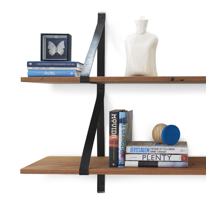 wooden shelves with black leather brackets