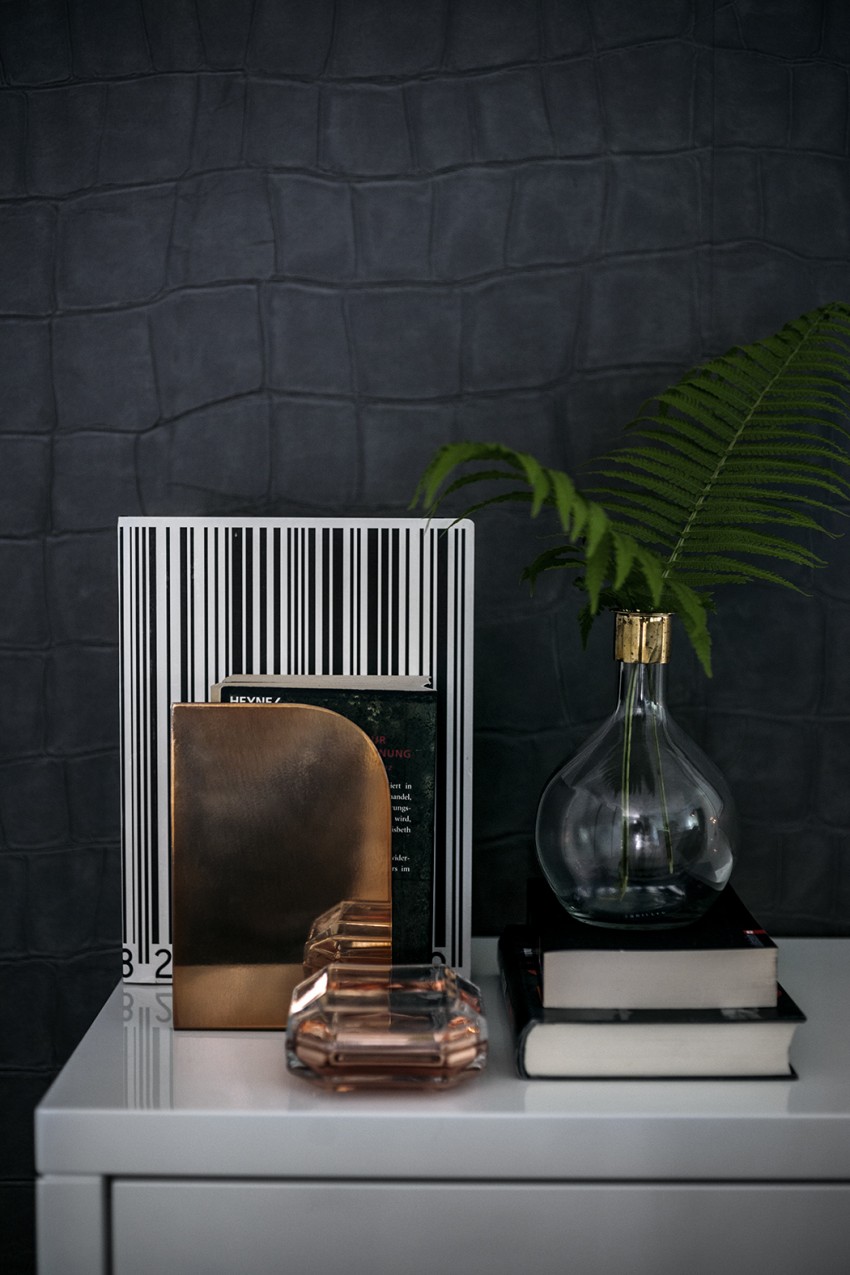 balance a black wall with metallics to bounce the light and houseplants for colour