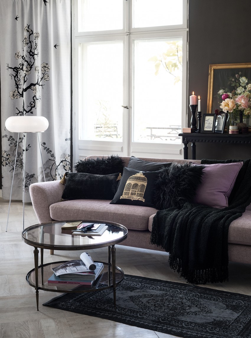 black walls, pink sofa and metallic detail