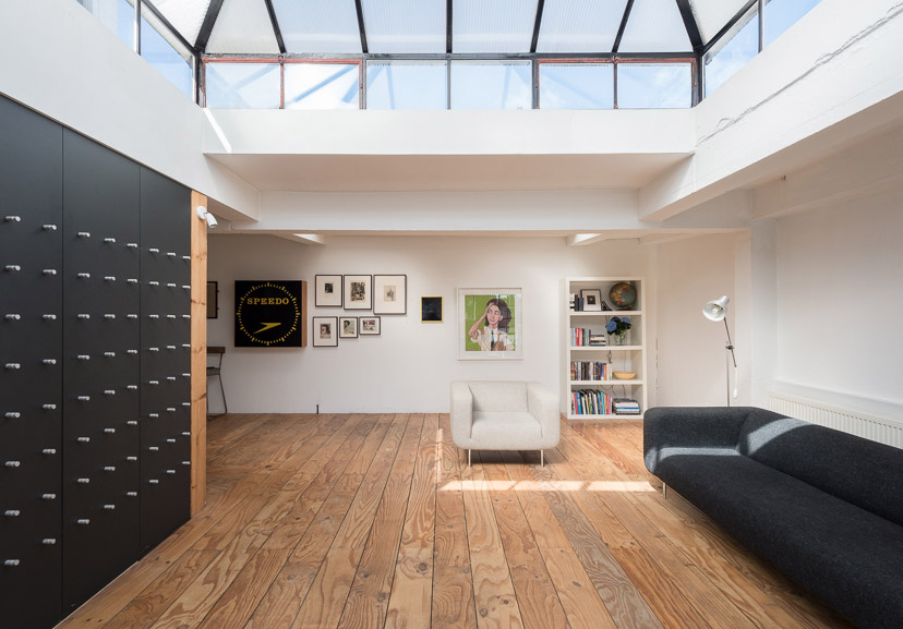 huge skylight, wooden floor black sofa