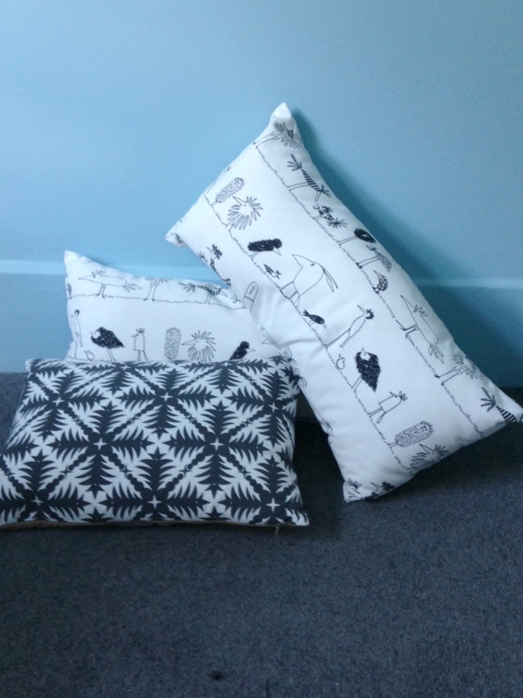 black and white cushions charcoal carpet blue walls