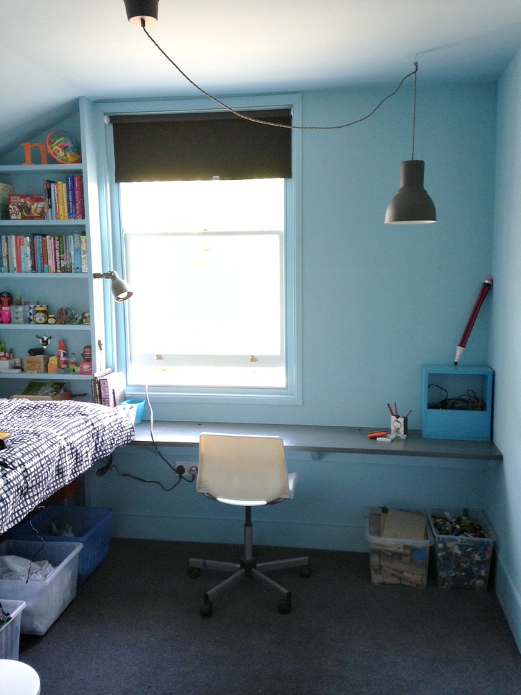 blue bedroom, grey carpet, built in desk and bed