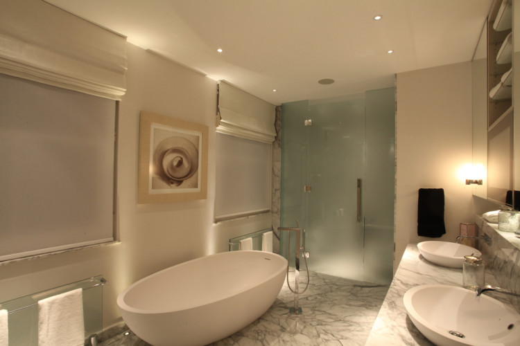 in addition to ceiling lights the owners have installed floor lights to highlight the bath and shower