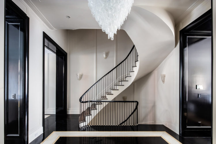 black doors and white curving staircase