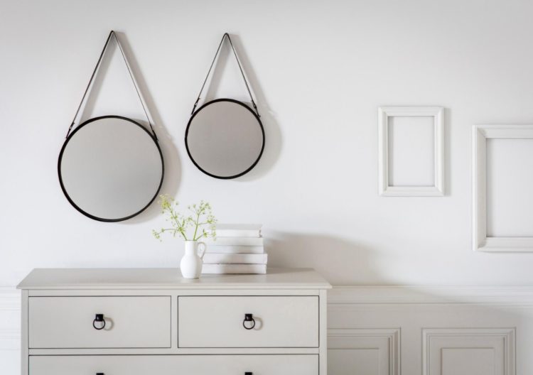 pair of round mirrors with faux leather strap