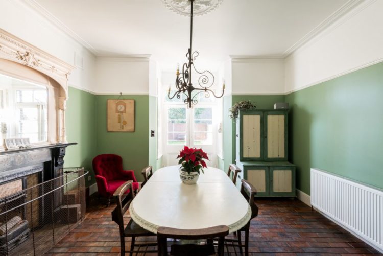 green-diniing-room-with-brick-floor-via-the-modern-house