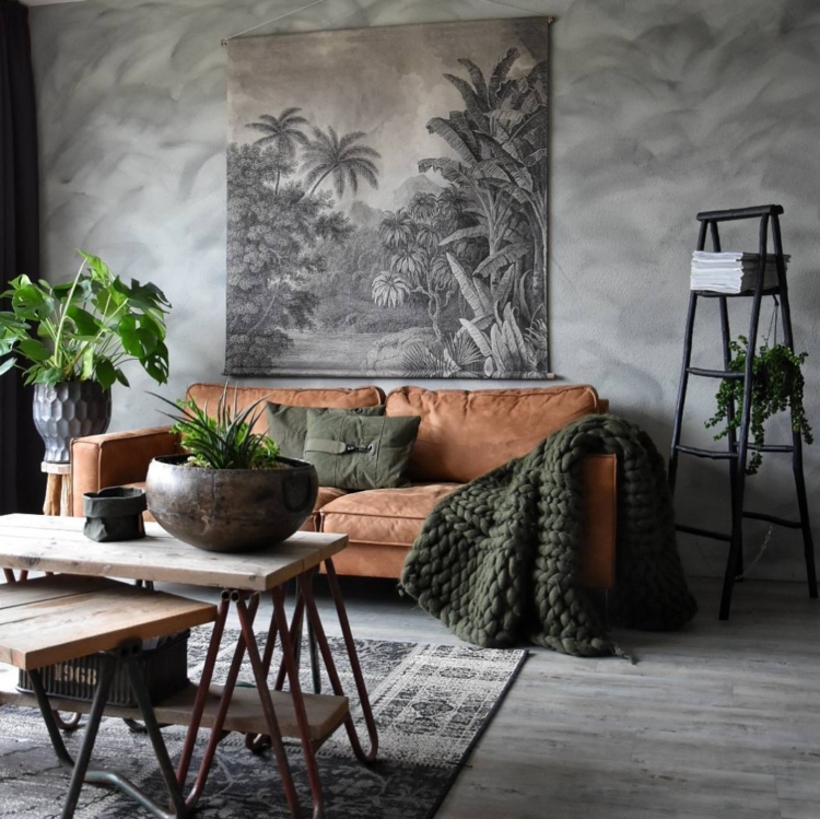 brown leather sofa and plants in the home of yvonne kwakkel