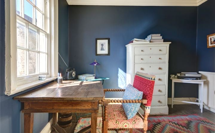 navy blue study with vintage desk via savills