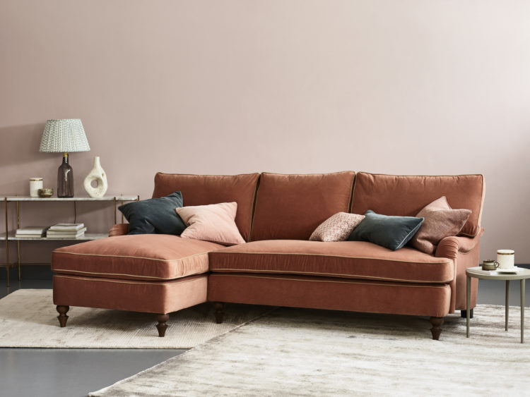 put a pale orange sofa against a soft pink wall for a warm and modern look