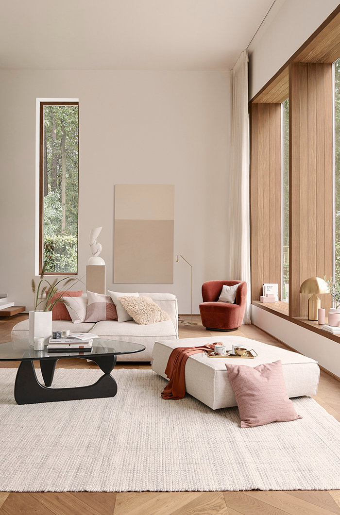 Kate Watson-Smyth looks at interior trends and the recent beige revival. Layering with different textures and adding accent colours create a modern look. The tall proportions and windows of the living room by H&M home help to keep the scheme light and contemporary. #modernliving #livingroom #madaboutthehouse