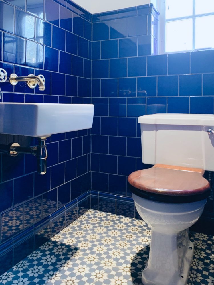 cobalt blue loo and brass taps at Sophie Robinson's house