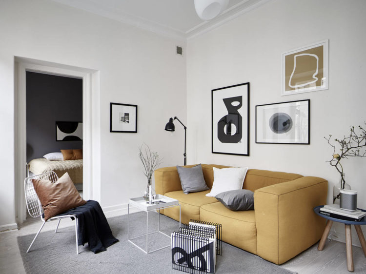 white room with mustard sofa via stadshem