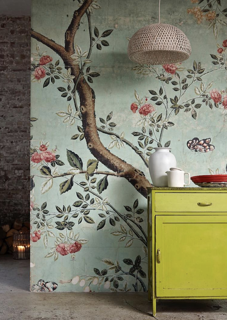 Journalist Kate Watson-Smyth looks at living with calming colours and how we react to them. A bold floral mural wallpaper has a calming and restful palette of green and pink is combined with an unexpected yellow cabinet for a modern touch. #madaboutthehouse #surfaceview #muralwallpaper