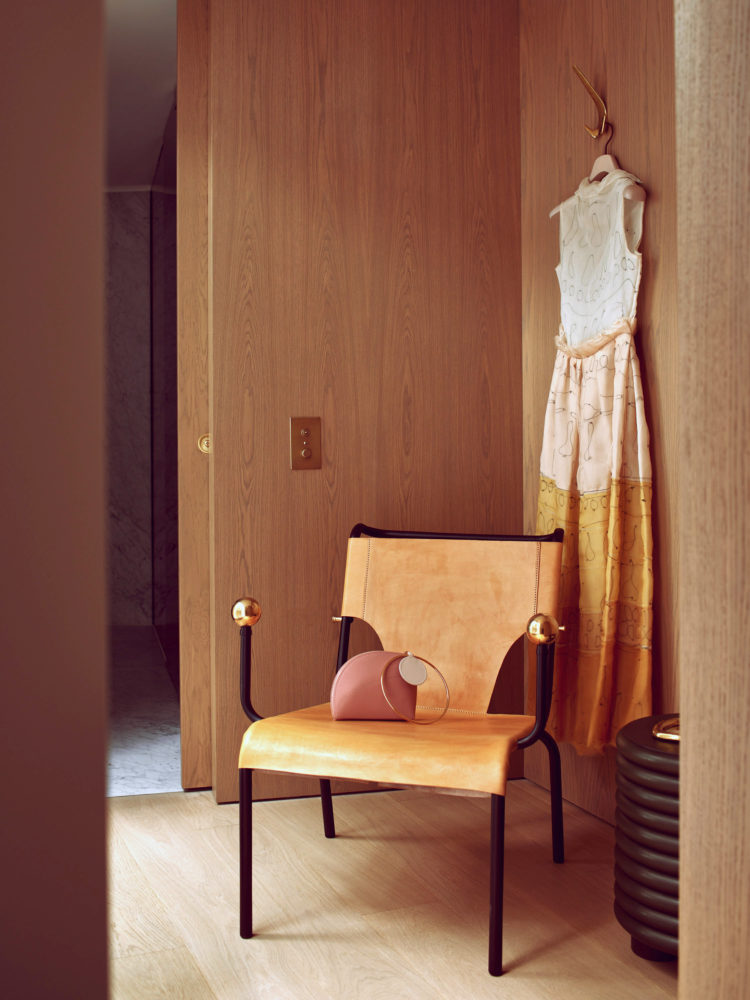 The snug; Bola de Latao chair by Lina Bo Bardi for Etel, and Roksanda bag and dress. CREDIT: PHOTOGRAPHY BY MICHAEL SINCLAIR, STYLING BY OLIVIA GREGORY