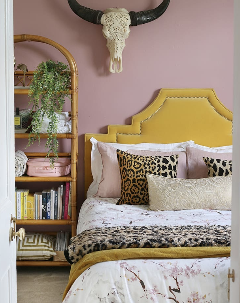 pink wall and yellow bed