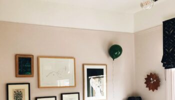 Kate Watson-Smyth looks at how you can instantly update your home without spending money. Her bedroom's pale pink walls features a gallery wall which she has been slowly growing. One of her tips is to move pictures around or re-arrange a gallery wall or swap art from upstairs to down so you can see it more. #gallerywall #pinkbedroom #madaboutthehoue