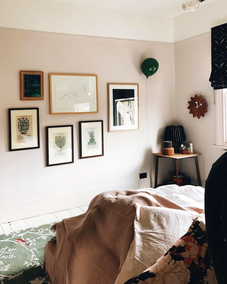 Kate Watson-Smyth looks at how you can instantly update your home without spending money. Her bedroom's pale pink walls features a gallery wall which she has been slowly growing. One of her tips is to move pictures around or re-arrange a gallery wall or swap art from upstairs to down so you can see it more. #gallerywall #pinkbedroom #madaboutthehoue