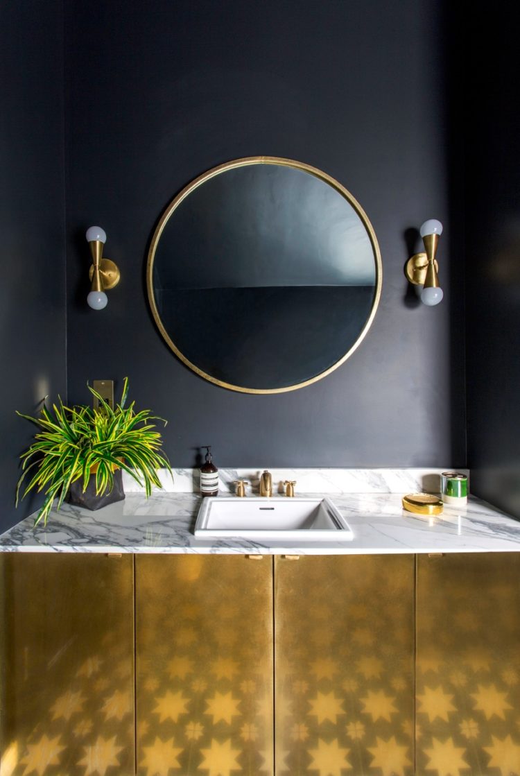 Kate Watson-Smyth looks at ways of introducing gold accents to a scheme. Here the brass vanity unity in a black bathroom helps to bounce the light around the room. #blackbathroom #brasscabinet #madaboutthehouse