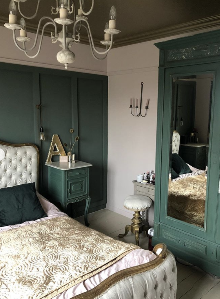 In this room the ceiling is gold which matches the French bed perfectly while the walls are a soft creamy pink. The wall behind the bed has been panelled to create the look of a giant bedhead while the freestanding wardrobe has been painted to match so the room looks cohesive and pretty. #greendecor #bedroom #madaboutthehouse