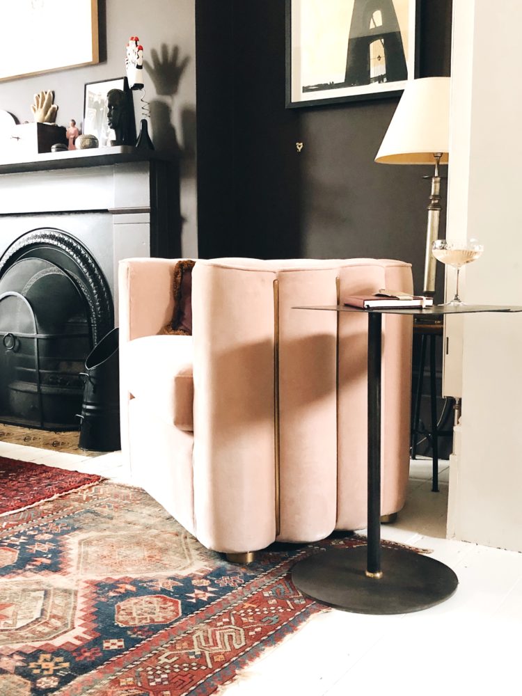 The Adriana chair in nude in the home of Kate Watson-Smyth against the dark chocolate walls and vintage kilim rug. The Anthropologie x soho home collaboration #madaboutthehouse #armchair