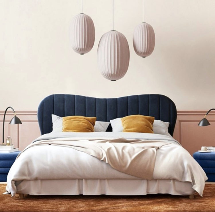 Kate Watson-Smyth looks at ways of injecting touches of mustard to scheme. Here a pale pink bedroom with navy headboard and side tables has the simple addition of mustard cushions to liven the scheme. #mustardaccents #madaboutthehouse #bedroom
