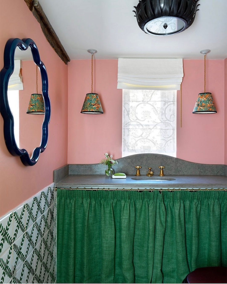 Bathroom by Beata Heuman with green sink skirt