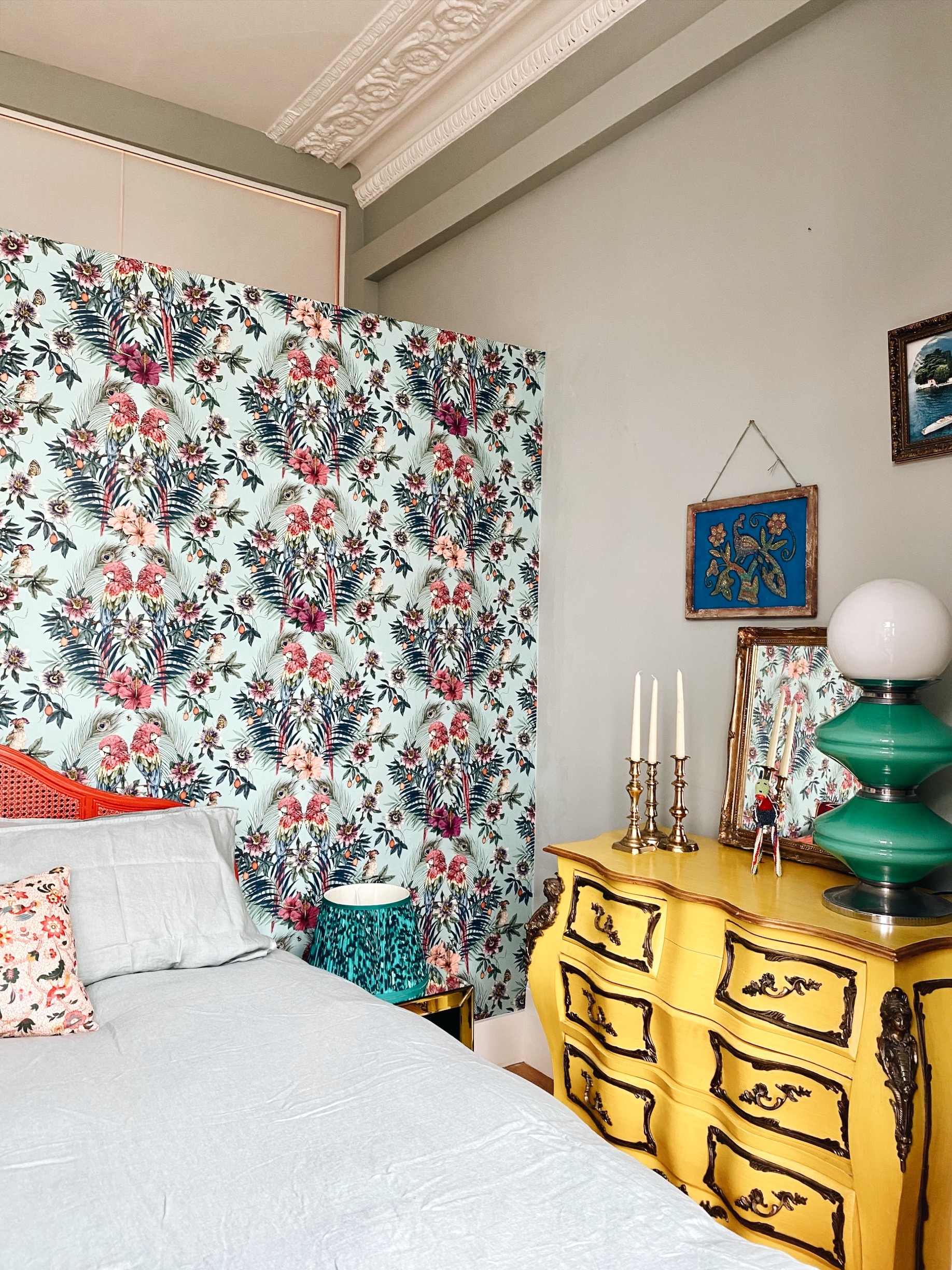 yellow painted vintage furniture in the home of Matthew Williamson with his own wallpaper design