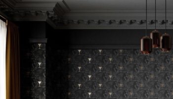 Half height black panelled wall and black cat print wallpaper catitude by divine savages. Charcoal velvet headboard grey painted cornice and ceiling