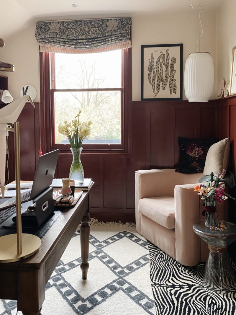 office of madaboutthehouse, burgundy half panelled walls, pale pink armchair, vintage wooden desk and monochrome geometric rugs.
