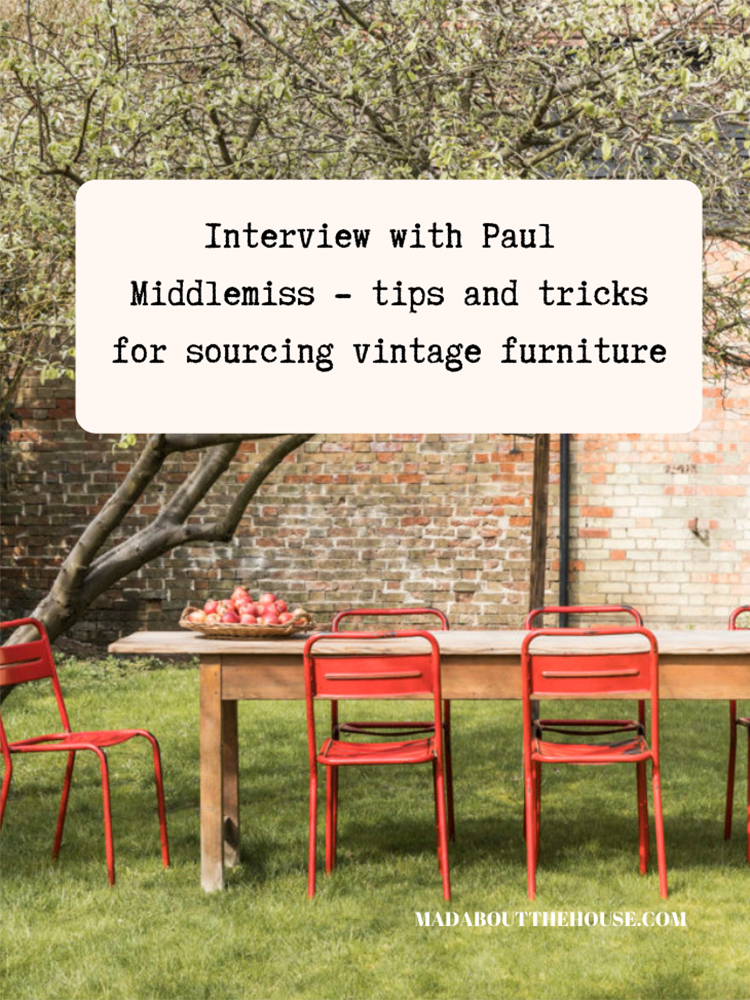 Vintage red metal dining chairs and large wooden table set in a walled garden. Pinterest graphic Mad about the house