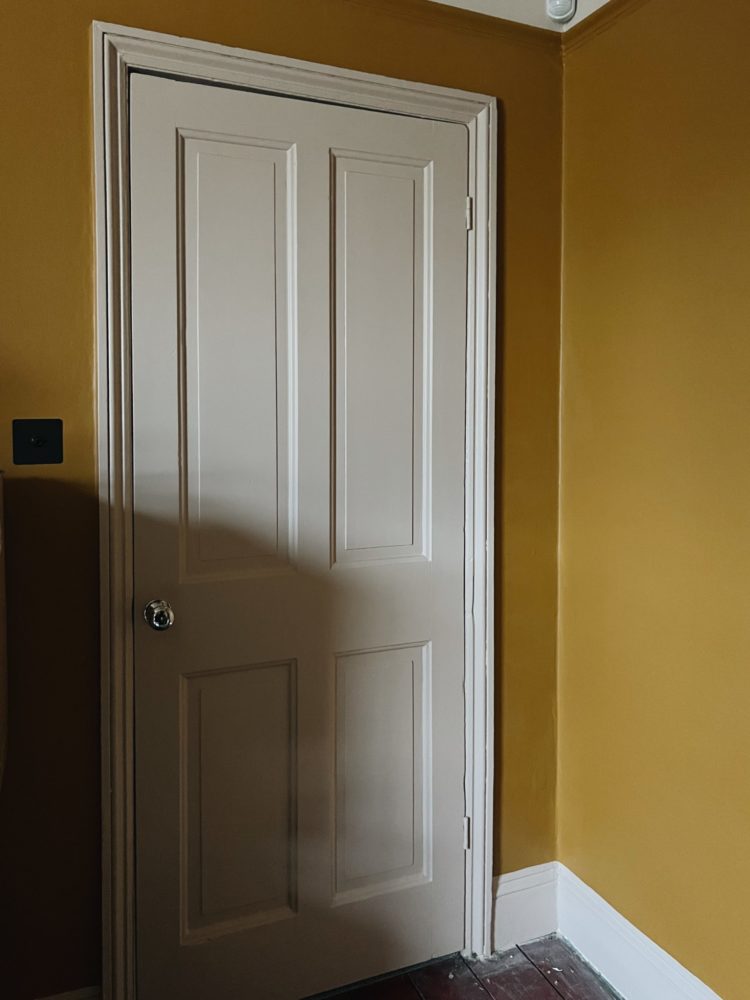 wall painted in middle buff from little greene paint company with ceiling in masquerade light and door and woodwork in masquerade mid